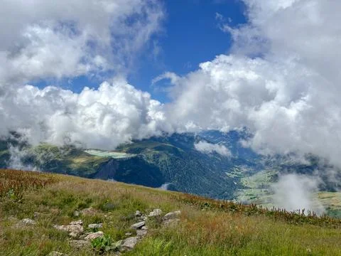 Cloudy alpine valley view from mountain meadow in Les Contamines-Montjoie, .. Stock Photos