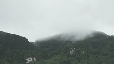 Cloudy and mist moving on sky over peak of island mountain after rainfall Stock Footage 153506424
