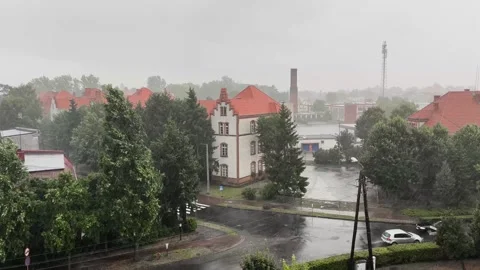 Cloudy and rainy day in a small town, crossroads of streets Stock Footage 252045347