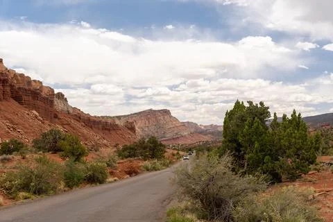 A cloudy and sunny view of red rocks at Capitol Reef National Park in Utah. Stock Photos