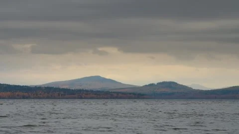 Cloudy Autumn Day Over Forested Mountains and Lake Stock Footage 325454020
