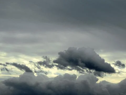 Cloudy autumn sky with gray clouds and yellow gap Stock Photos