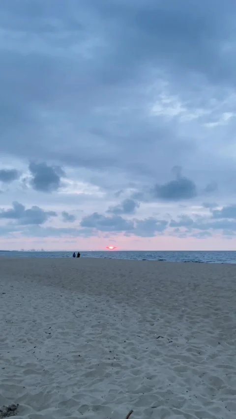 Cloudy Beach Sunset with Dramatic Sky and People Silhouettes Stock Footage 340333603