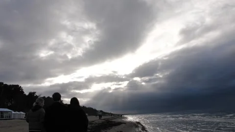 Cloudy Beach Sunset with Ocean Waves creates serene atmosphere by the shore Stock Footage 278925421