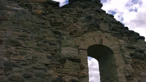Cloudy blue skies through view of castle archway ruins Stock-Footage 336952570