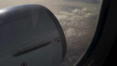 Cloudy blue sky and jet engine view from the window of commercial airplane. Stock-Footage 232961240