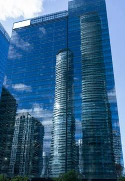 Cloudy blue sky reflection skyscraper glass exterior white blank billboard Stock Photos