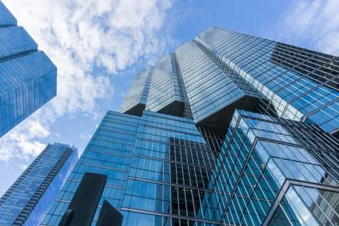 Cloudy blue sky reflection skyscraper glass exterior Stock Photos