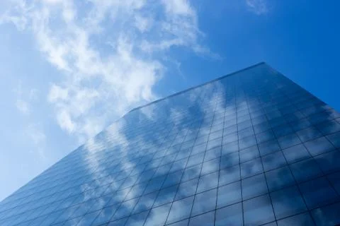Cloudy blue sky reflection skyscraper glass exterior Stock Photos