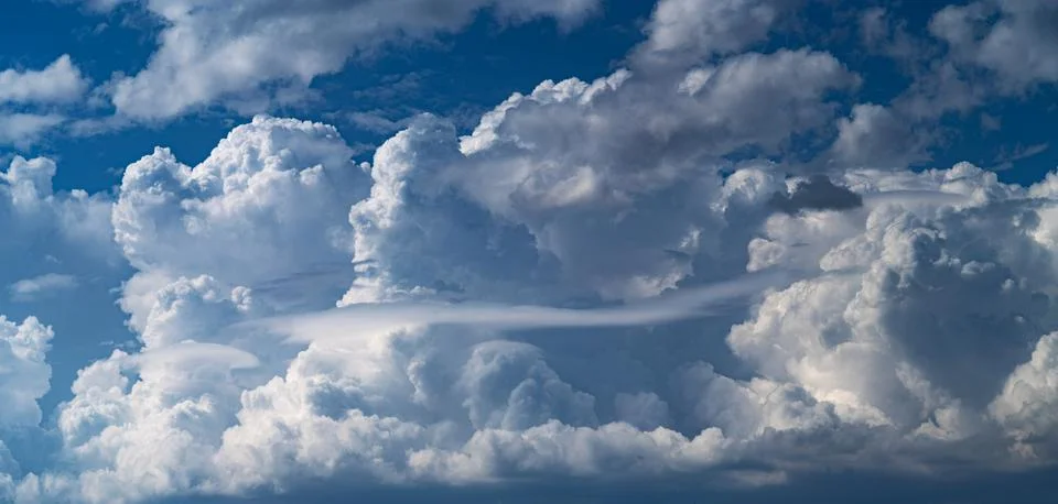 Cloudy blue sky with white clouds in the form of lenses lenticular ; Below .. Stock Photos