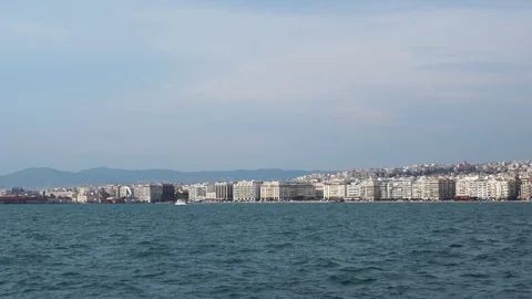 Cloudy blue summer sky over calm sea in big ancient Greece port city Video stock 95392872