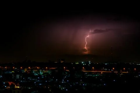 Cloudy with Bright lightning bolt strikes in the rural landscape of small cit Stock Photos
