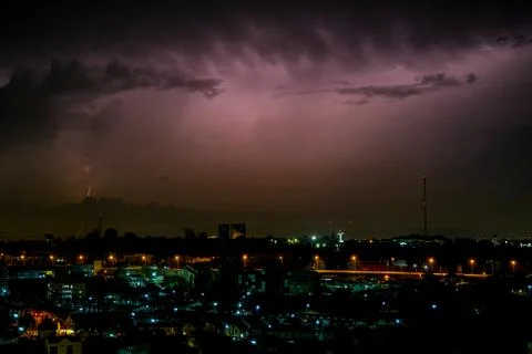 Cloudy with Bright lightning bolt strikes in the rural landscape of small cit Stock Photos