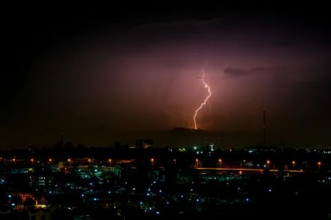 Cloudy with Bright lightning bolt strikes in the rural landscape of small cit Stock Photos
