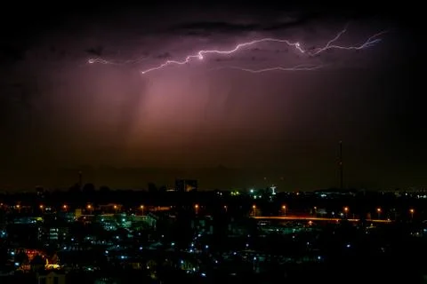 Cloudy with Bright lightning bolt strikes in the rural landscape of small cit Stock Photos