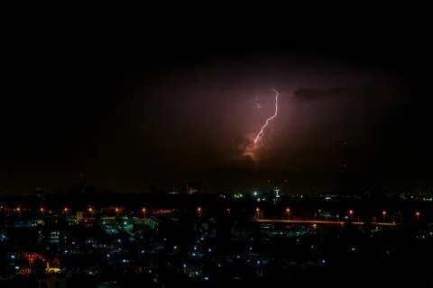 Cloudy with Bright lightning bolt strikes in the rural landscape of small cit Stock Photos
