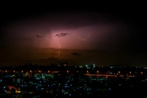 Cloudy with Bright lightning bolt strikes in the rural landscape of small cit Stock Photos
