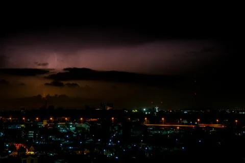 Cloudy with Bright lightning bolt strikes in the rural landscape of small cit Stock Photos