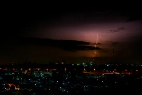 Cloudy with Bright lightning bolt strikes in the rural landscape of small cit Stock Photos