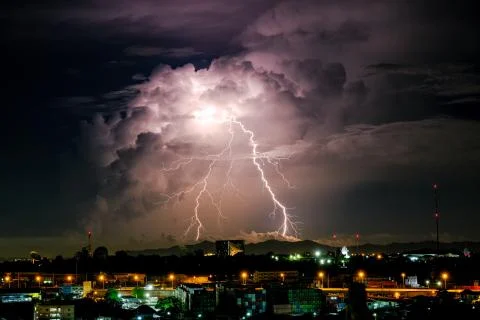 Cloudy with Bright lightning bolt strikes in the rural landscape of small cit Stock Photos