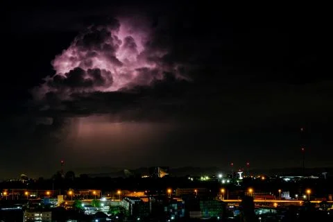 Cloudy with Bright lightning bolt strikes in the rural landscape of small cit Stock Photos
