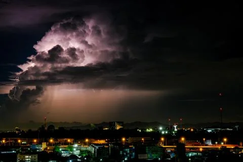 Cloudy with Bright lightning bolt strikes in the rural landscape of small cit Stock Photos
