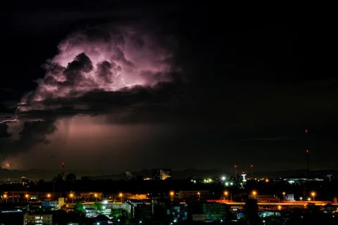 Cloudy with Bright lightning bolt strikes in the rural landscape of small cit Stock Photos