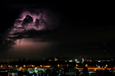 Cloudy with Bright lightning bolt strikes in the rural landscape of small cit Stock Photos