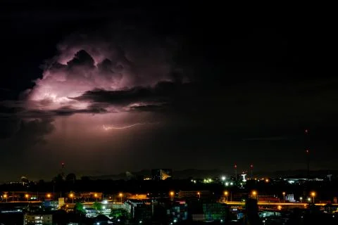 Cloudy with Bright lightning bolt strikes in the rural landscape of small cit Stock Photos