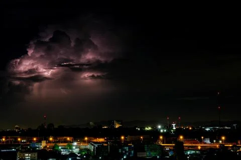 Cloudy with Bright lightning bolt strikes in the rural landscape of small cit Stock Photos