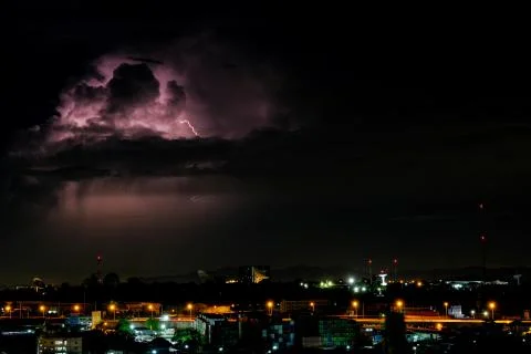 Cloudy with Bright lightning bolt strikes in the rural landscape of small cit Foto stock
