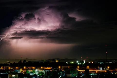 Cloudy with Bright lightning bolt strikes in the rural landscape of small cit Stock Photos