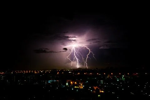 Cloudy with Bright lightning bolt strikes in the rural landscape of small cit Stock-Fotos