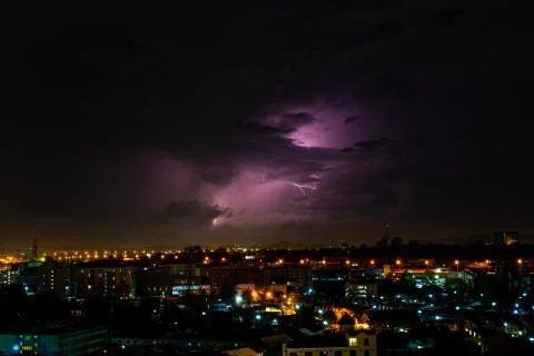 Cloudy with Bright lightning bolt strikes in the rural landscape of small cit Stock Photos