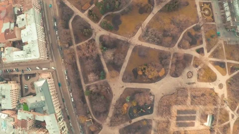 Cloudy city park in winter without snow, drone shot with old town in background Stock Footage 247371057