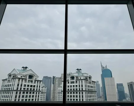 Cloudy city view from a window Stock Photos
