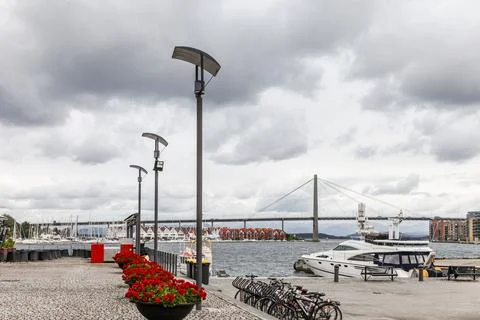 A cloudy day with a bridge in the background and a boat in the water in Sta.. Stock Photos