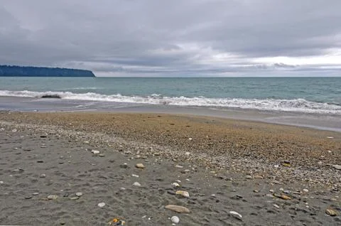 Cloudy day on a coatal beach Stockfoto's