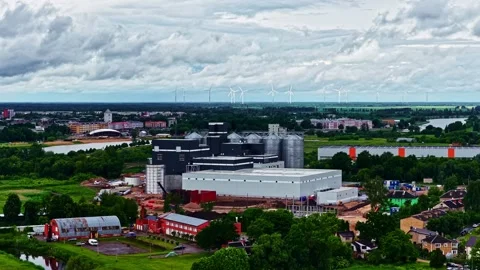 Cloudy Day Drone Flyover of Factory Complex and Countryside Town Stock Footage 341544474