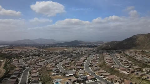 Cloudy day drone shot slowly reveals the patchwork of light and shadow Stock Footage 244692499