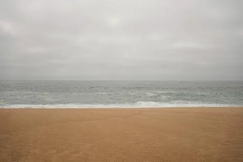 Cloudy day at the empty beach Stock Photos