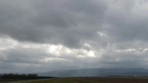 Cloudy day with a few slits of sunlight piercing through the sky. Stock Footage 257018373
