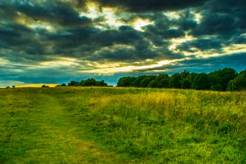 A cloudy day in a green valley. Stock Photos