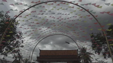 Cloudy day look up sky colour flags temple move foward in car Stock Footage 228706312