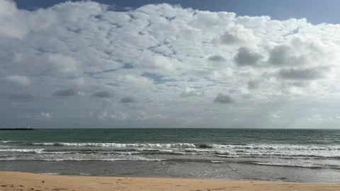 Cloudy day at a Malaysian beach with ocean waves and lighthouse Stock Footage 328489507