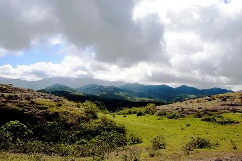 A cloudy day with mountains in the background Stock Photos