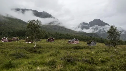 Cloudy day with mountains cabins Stock Footage 122995726