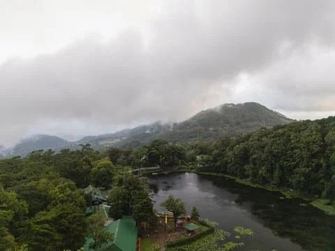 Cloudy day over a forest and lake in a mountainous area Fotos Stock
