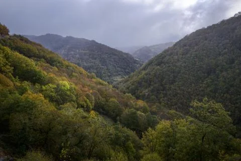 Cloudy day over the Forested Mountains Stock Photos