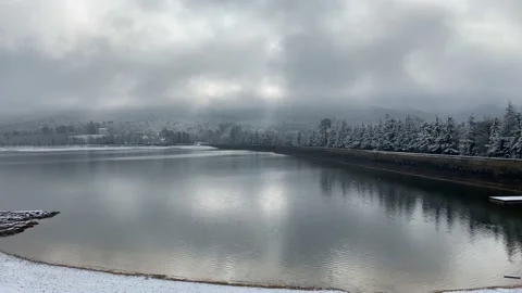 Cloudy Day Over Lake With Snow Falling Stock Footage 150428502